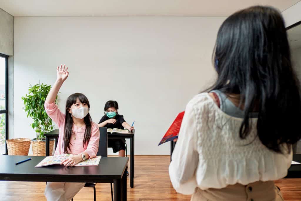 Kids Raising Up Hand in English Lessons On Campus