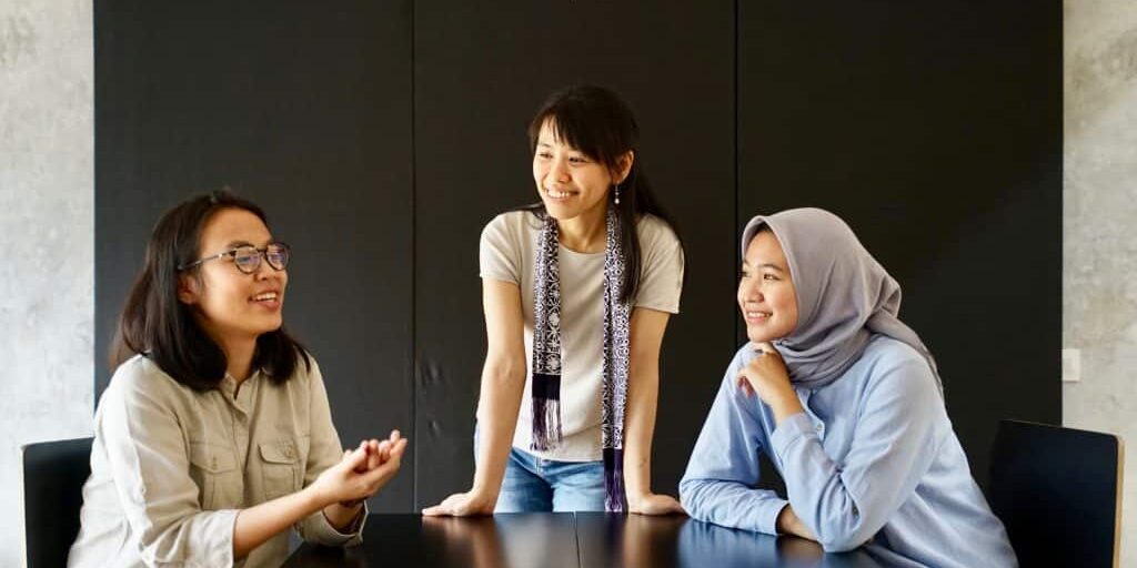 Adults Student and Teacher Conversing on Campus