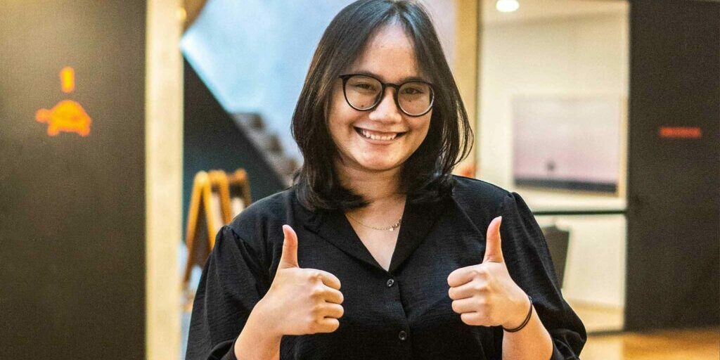 IELC-adult-student-thumbs-up-with-black-dress