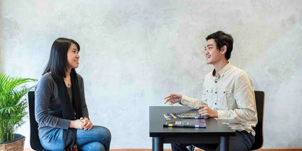 Student-and-teacher-having-converstation-1024x732 Student-and-teacher-having-converstation-1024x732